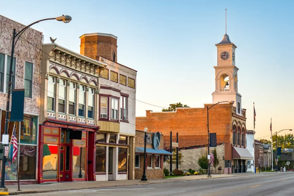 Commercial street in small rural U.S. town with storefronts and clocktower.
